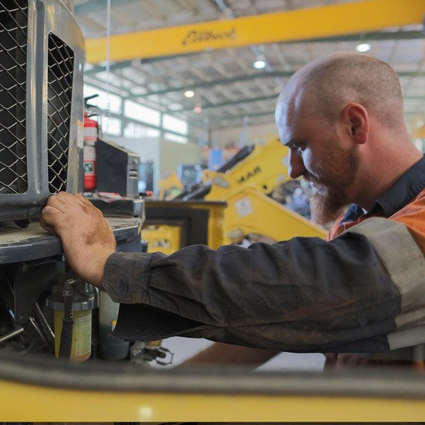 TBE staff member carring out a machine service